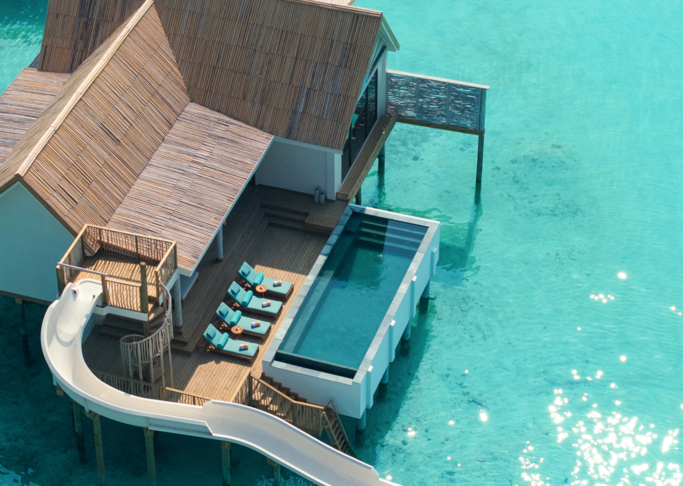 Rah Gili Maldives — Aerial view of a water pool villa with slide